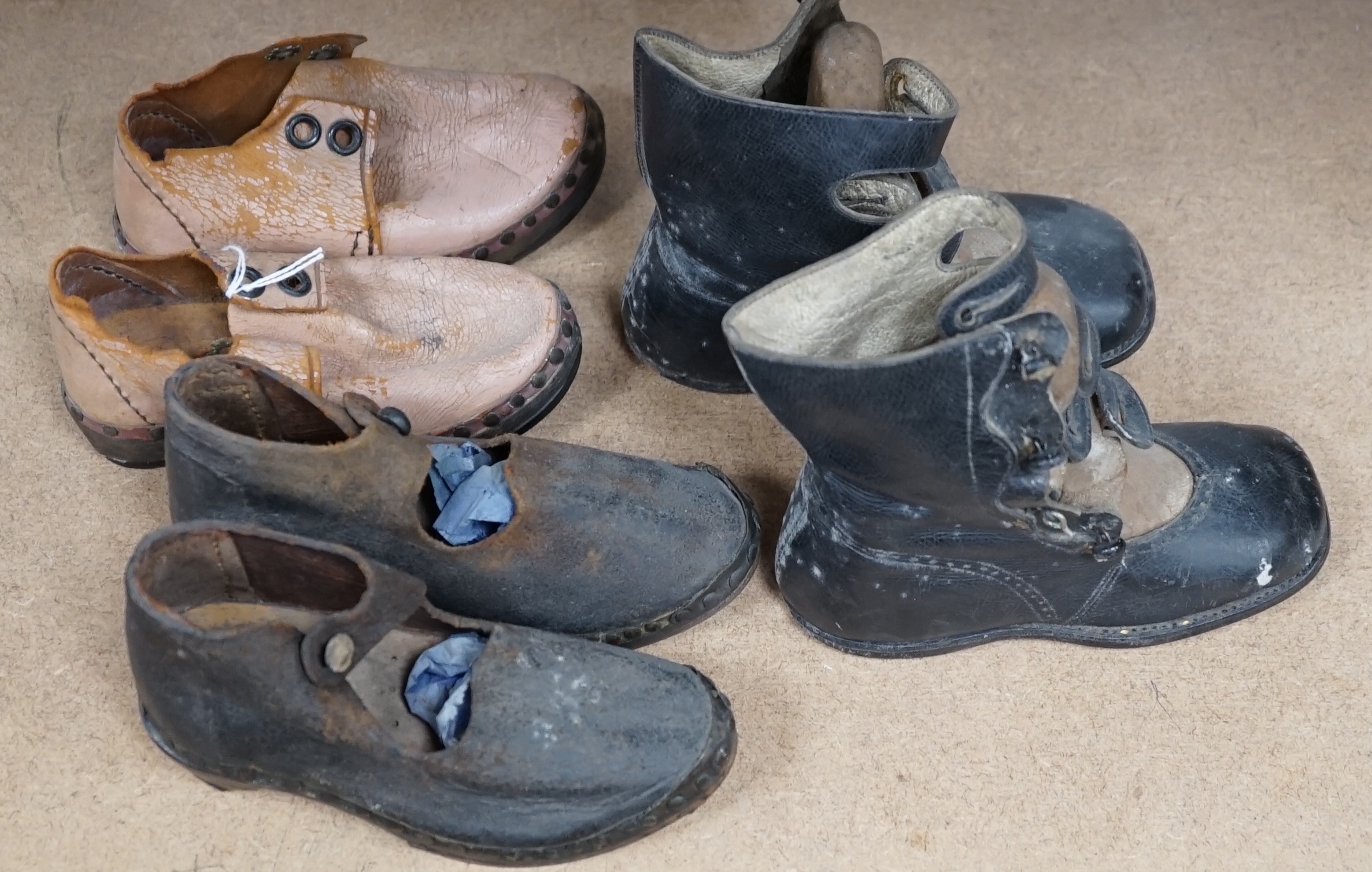 Three pairs of late 19th / early 20th century children’s boots and clogs, largest 14cm in length. Condition - poor to fair